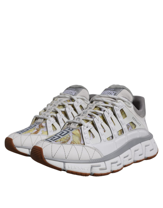 White sneakers with red accents and a patterned design on the side