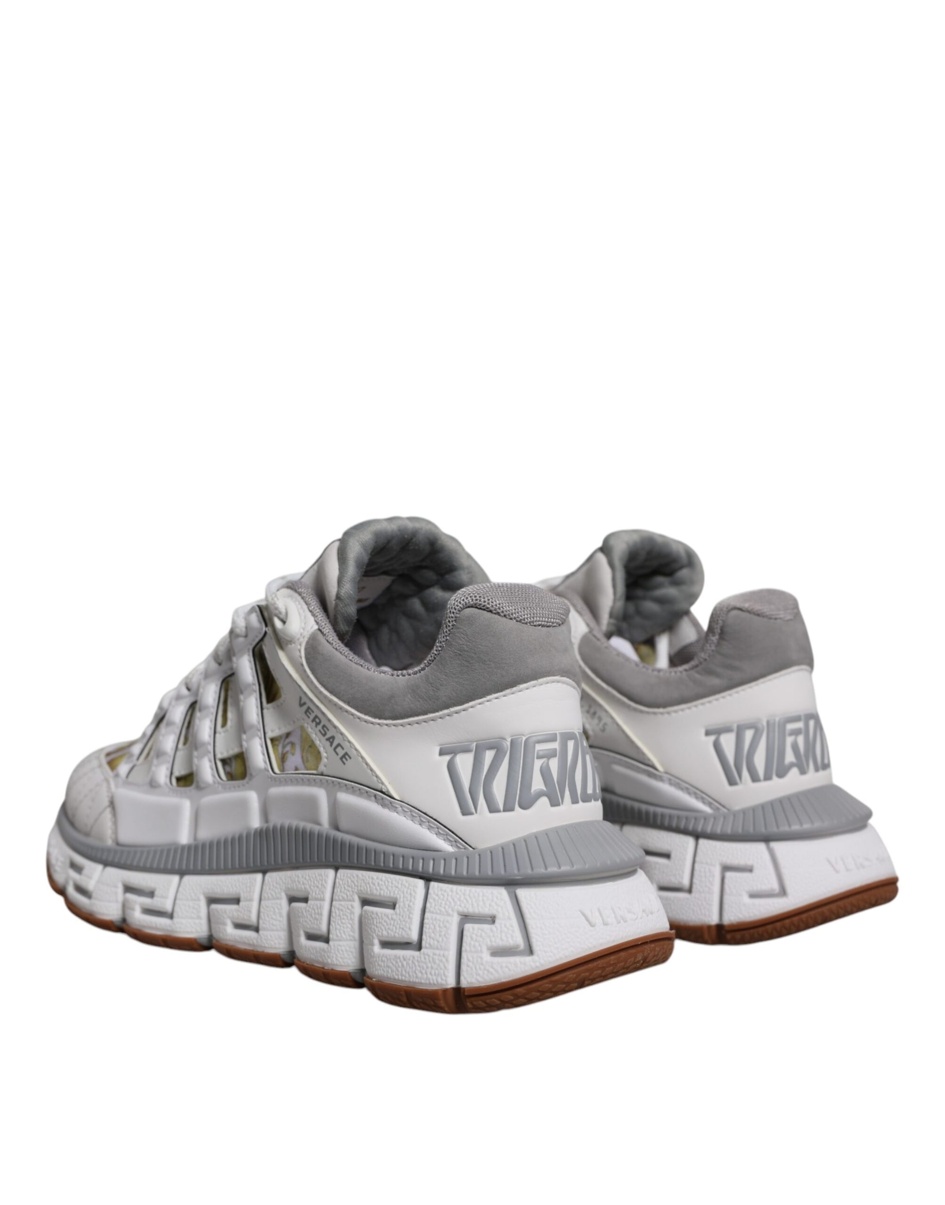 Pair of gray and white sneakers with black laces