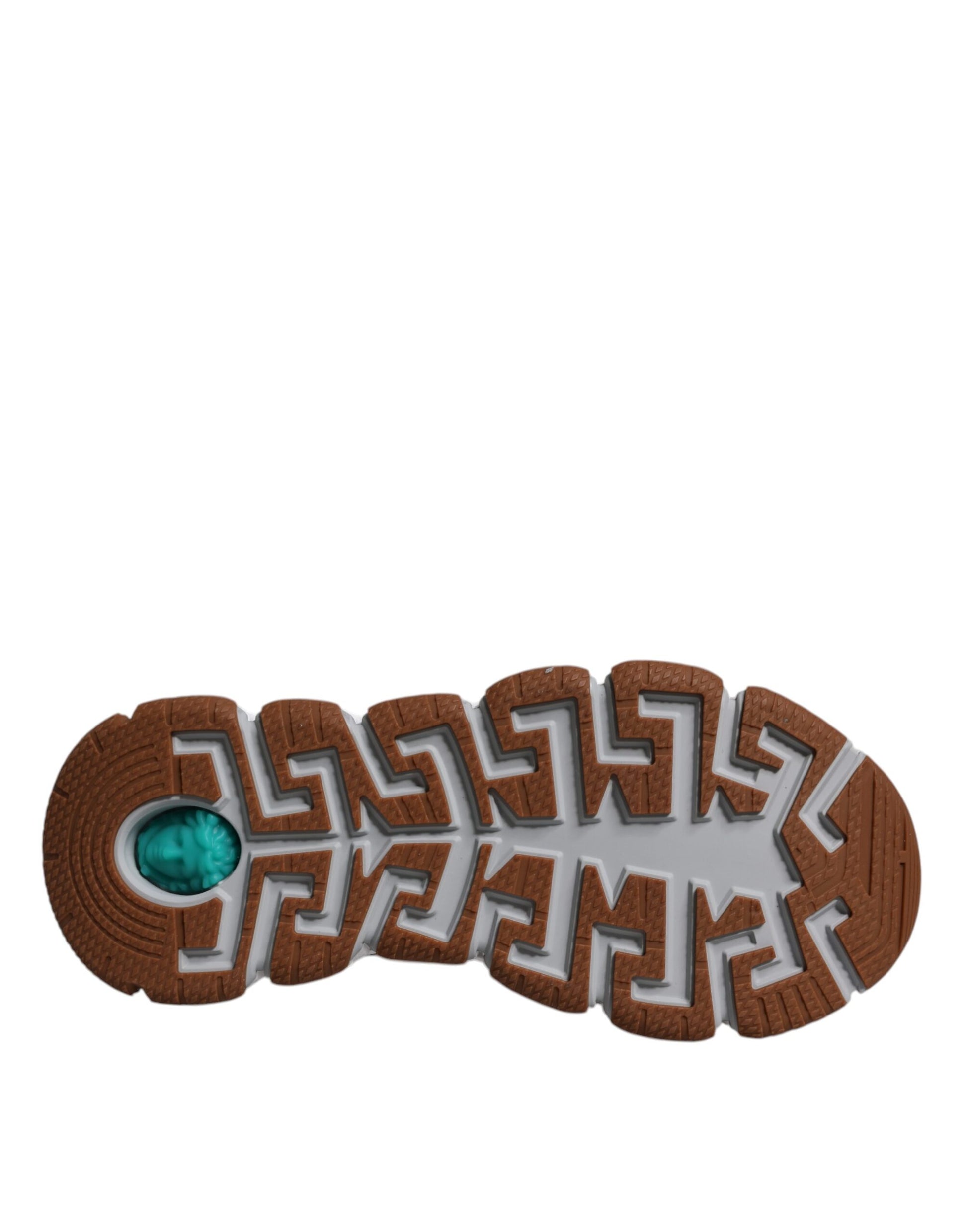 Brown shoe with blue gem in center and intricate design on sole